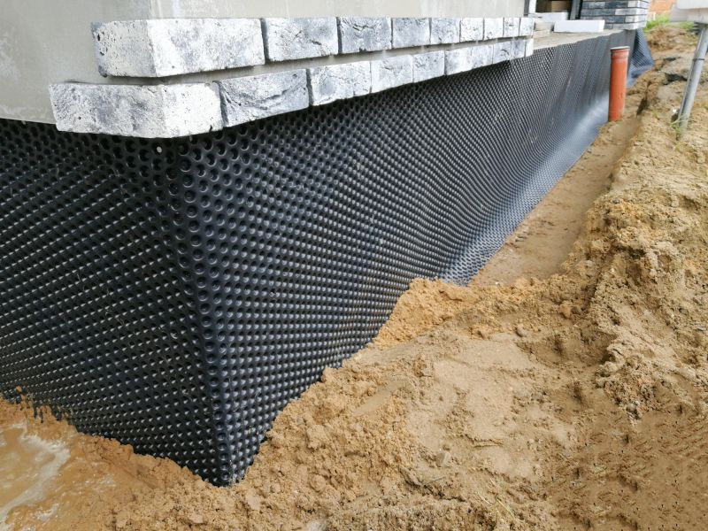 Waterproofing membrane installation on foundation wall